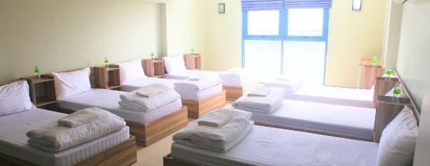 The shared dormitory at the Golden Jubilee Museum of Agriculture, with rows of single beds