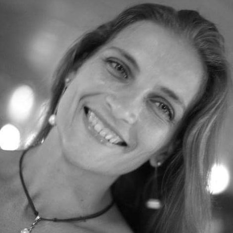 Olga Vita, naturopath and vitality coach, smiling — black-and-white portrait.
