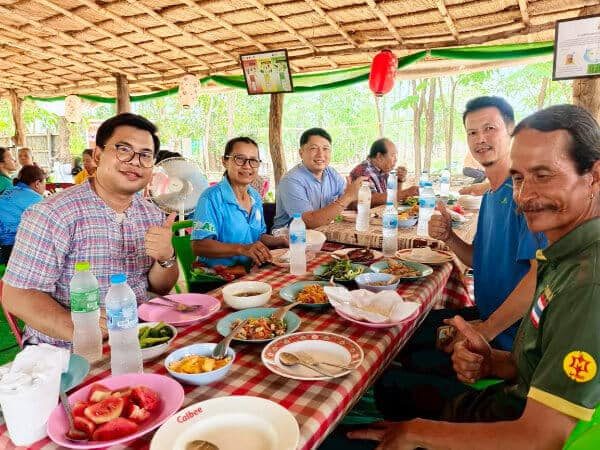 Members of Ubon's organic farming community sharing a communal lunch at a PGS organic farming event connected to Suan Na Ta Bua.