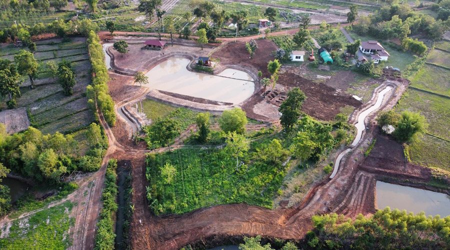 Aerial view of the farm showing ponds, contoured earthworks, swales and cultivated plots at Suwan Organic Farmstay, Phen, Udon Thani.