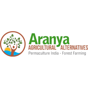 Aranya Agricultural Alternatives logo: a circular emblem of a figure with raised arms becoming a green tree above a blue river and rising sun, beside the words Aranya Agricultural Alternatives, Permaculture India - Forest Farming.