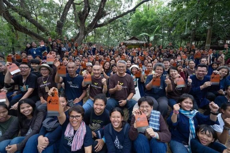 Course participants gathered under large shade trees at the Mab Ueang Agri-Nature Learning Center, a natural-farming and permaculture training centre in Chon Buri, Thailand.