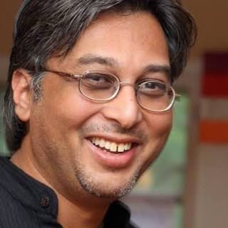 Manish Jain, education activist and co-founder of the Ecoversities Alliance, smiling in glasses - head-and-shoulders portrait.