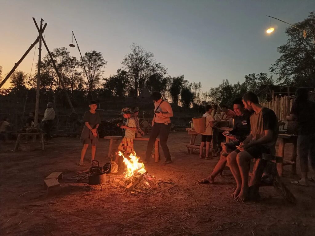 Course participants gathered around an evening campfire at Sahainan