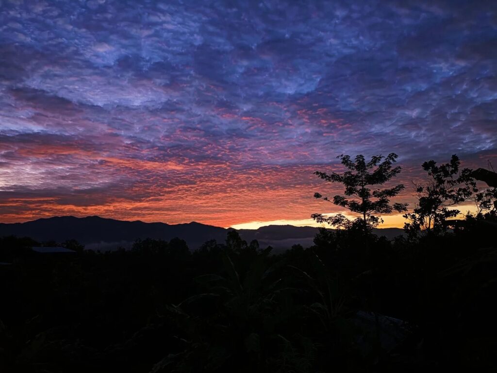 Sunrise over the forested hills surrounding Sahainan in Nan province