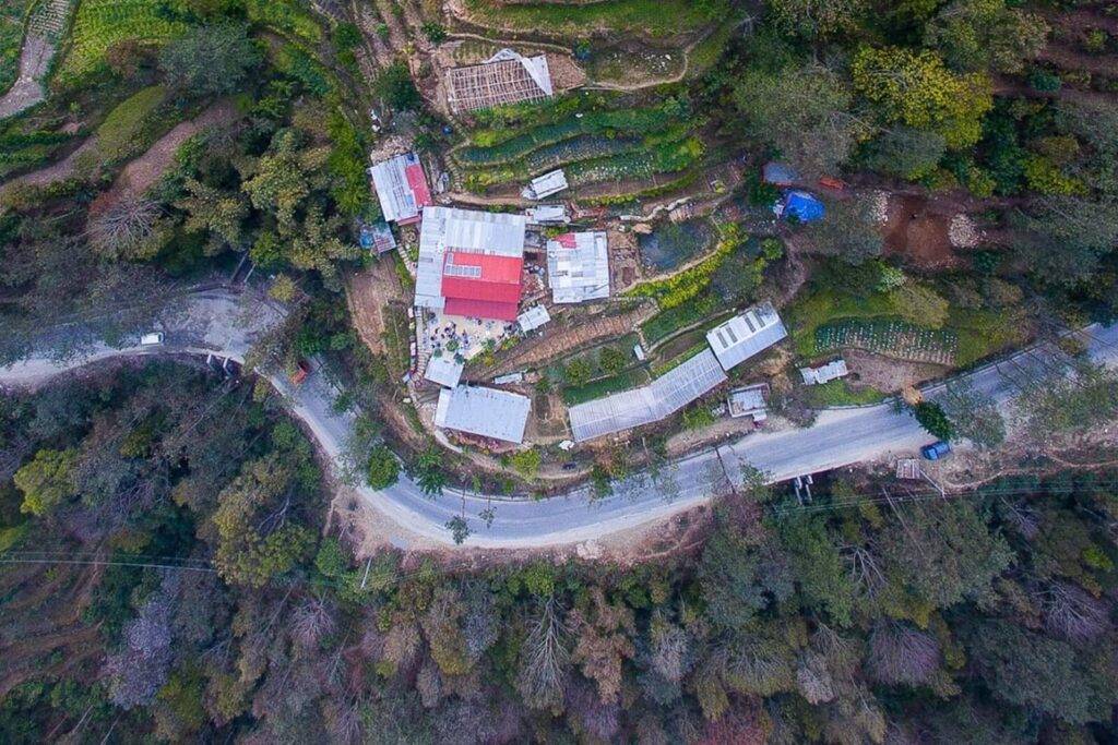 Aerial view of the HASERA farm buildings and terraced fields beside the road at Patalekhet, Nepal.